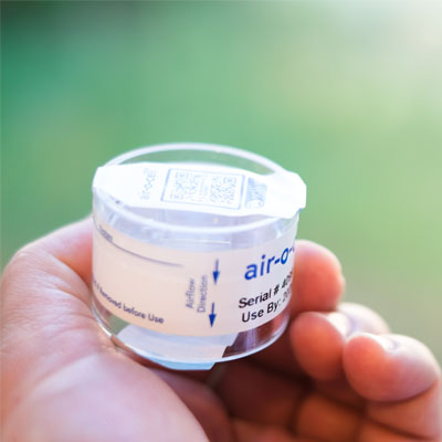 Air sample cartridge. Inspector holding air sample for mold lab testing and analysis.